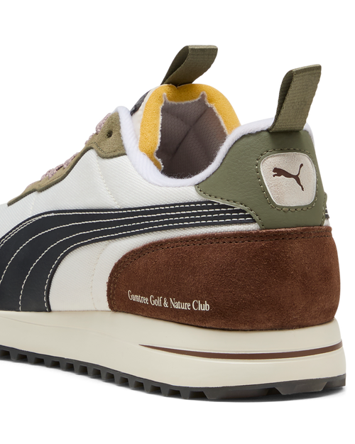 Close-up of a Puma sneaker with brown, white, and green color scheme on a white background