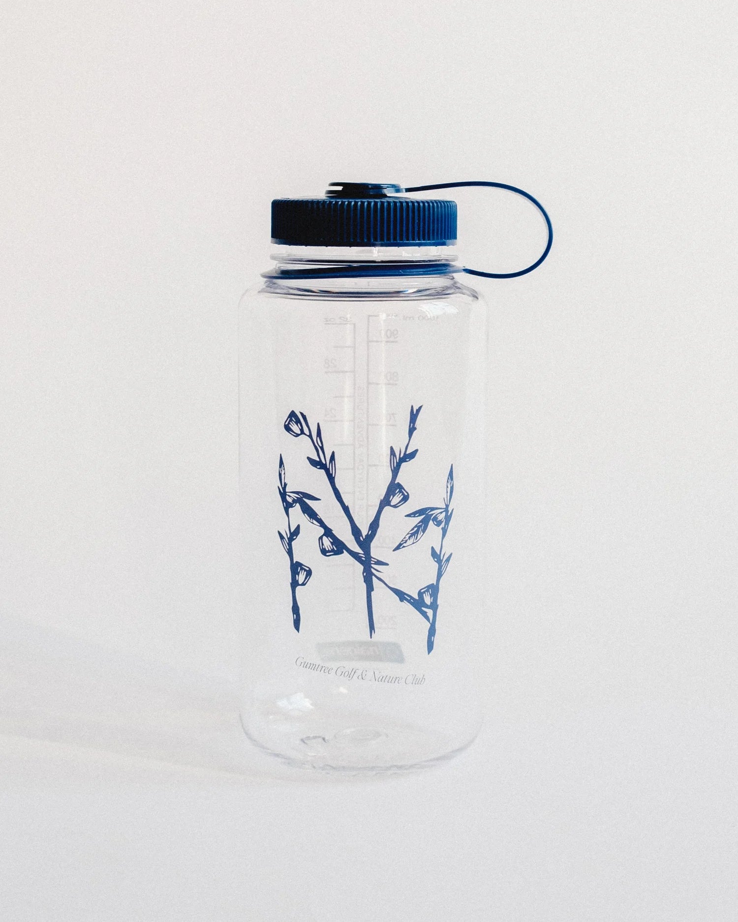 Clear water bottle with blue floral design and black cap on a white background