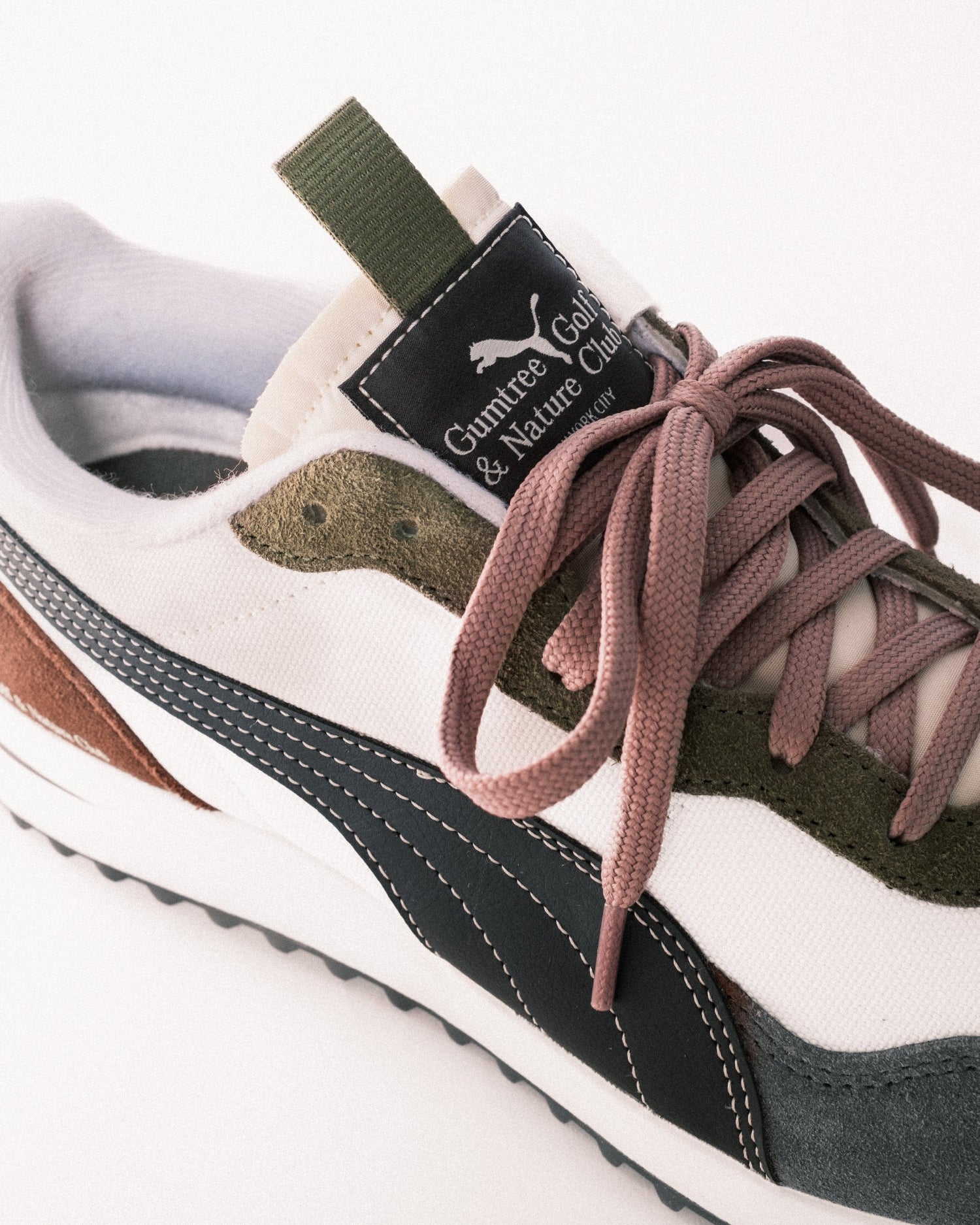 Close-up of a sneaker with visible branding on a white background