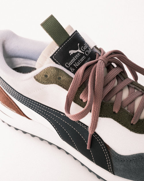 Close-up of a sneaker with visible branding on a white background