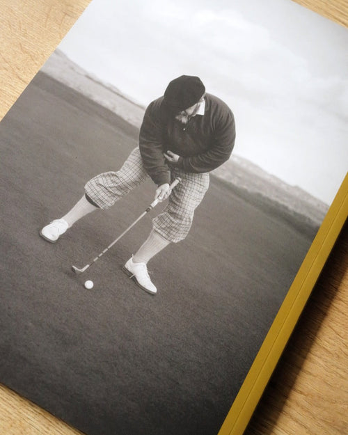 Golf-themed album with a black and white photo of a golfer on a wooden surface